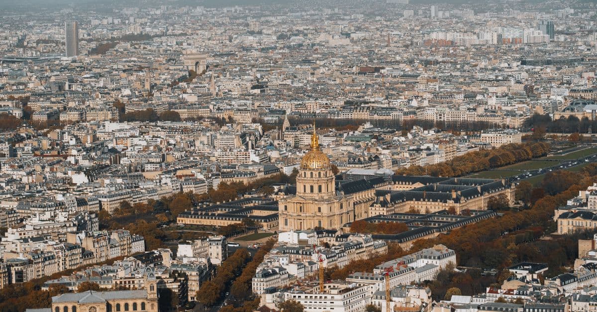 Stunning aerial view of the iconic Hôtel des Invalides surrounded by Paris cityscape.