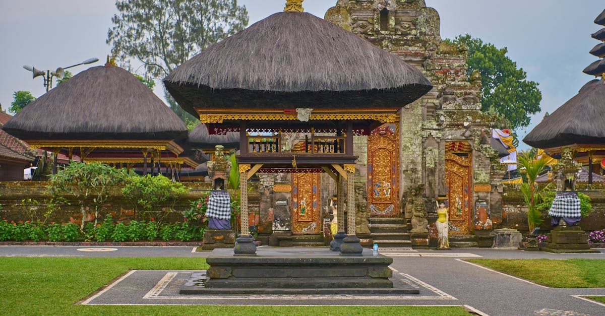 Traditional Balinese temple with thatched roofs and intricate carvings, ideal for budget travellers in the cheapest season![image