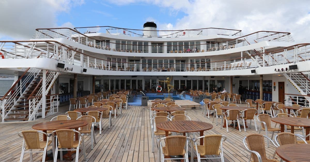 Cruise ship dining deck with tables and chairs representing lower-level carnival adventure deck plans for decks 4 to 6.