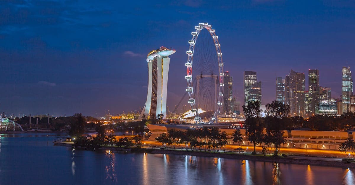 Singapore Flyer and Marina Bay Sands reflected on water at night, ideal scenery for travel eSIM users