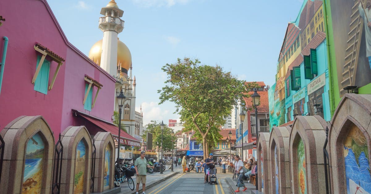 Colorful Kampong Glam street scene with Sultan Mosque and lively pedestrians in Singapore's cultural district