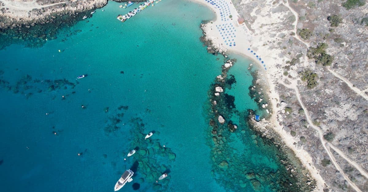 Crystal-clear turquoise waters and rocky shoreline at Protaras, one of Cyprus the country's top beach destinations.