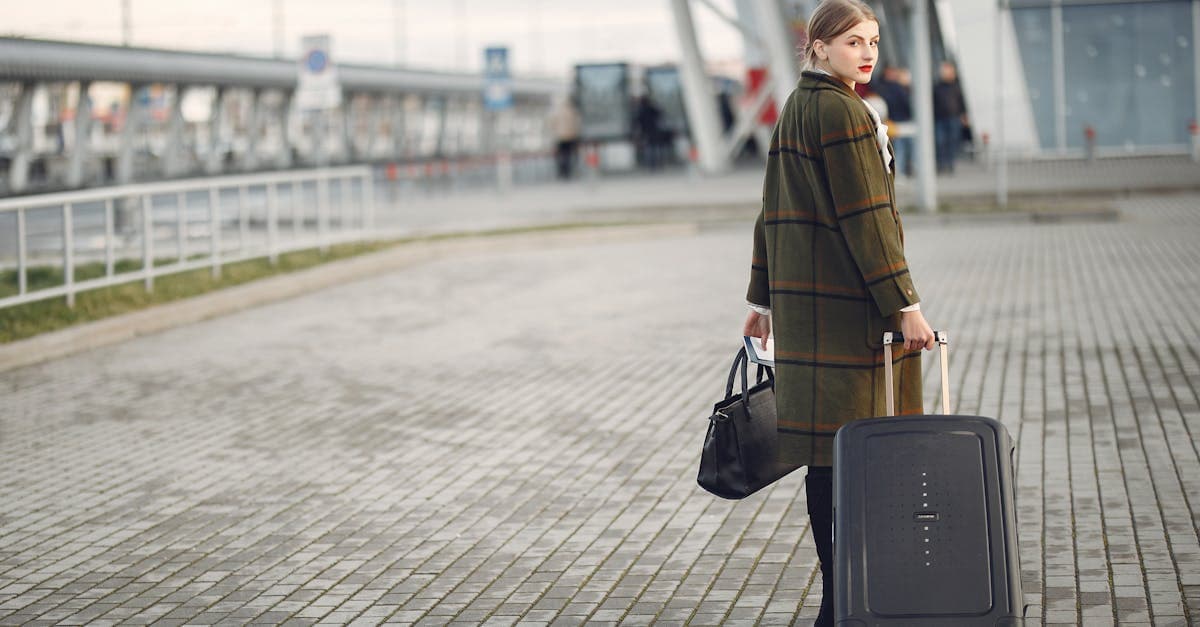 Stylish female traveller walking with a carry on suitcase through an Australian airport terminal