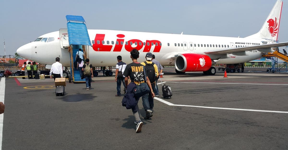 Passengers boarding a flight at an Indonesian airport on their way to arrange a Bali visa on arrival.