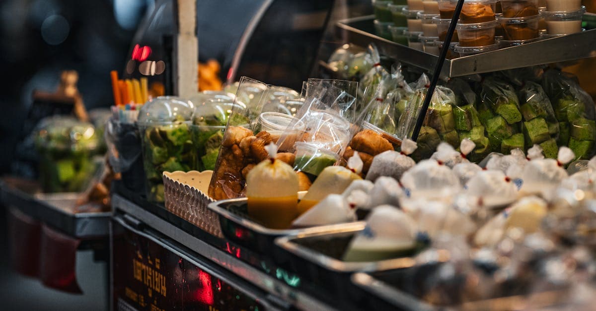 Colourful street food thailand stall displaying authentic Thai snacks, desserts, and traditional street food items.