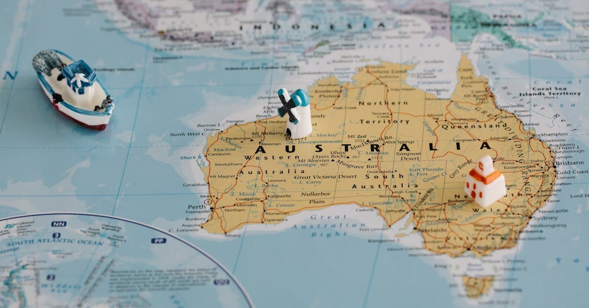 Miniature windmill and ship on a map highlighting cheapest countries to travel from Australia