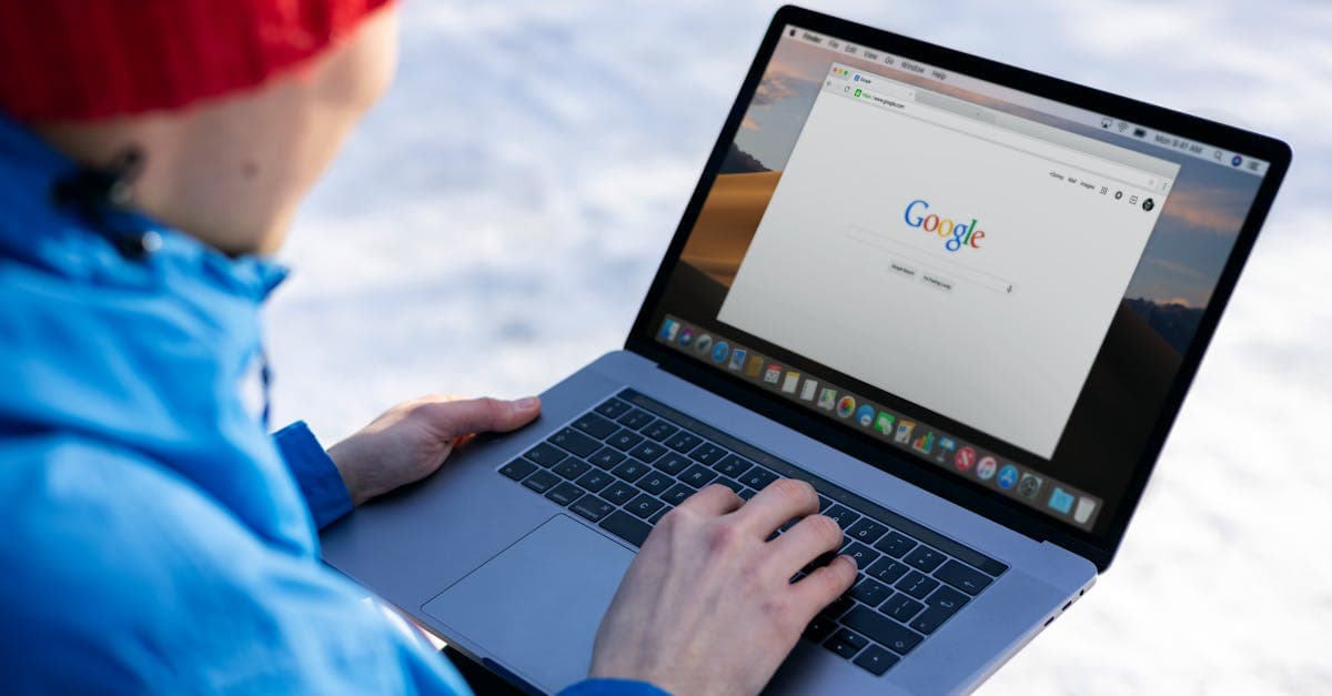 Traveller in winter clothing using a laptop outdoors to test whether portable wifi works reliably abroad