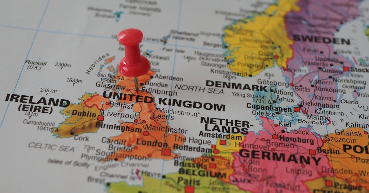 Close-up of a UK map with a red pin marking regional destinations across London, Scotland and Wales.