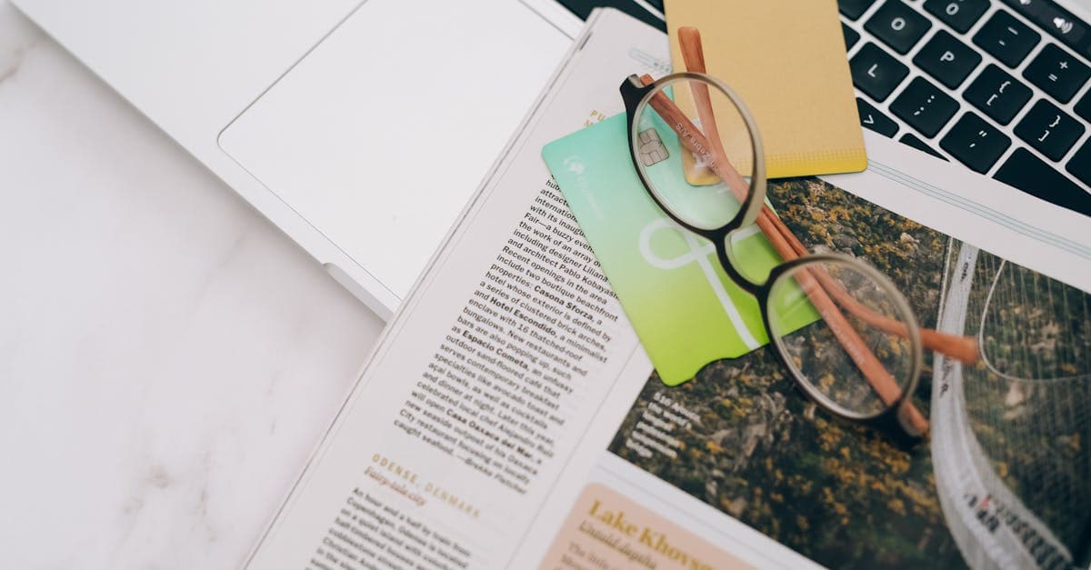 Passport, glasses, and laptop on desk for checking malaysia arrival card eligibility requirements![image