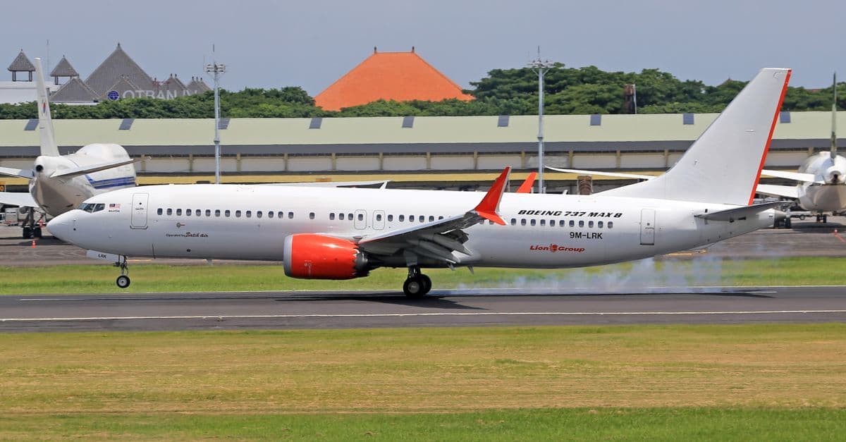 Boeing 737 MAX 8 touching down with visible smoke, marking the arrival of perth to bali flights