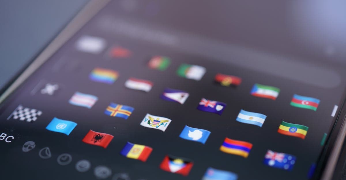 Smartphone screen with world flag emojis representing turning on roaming settings for tmobile international roaming