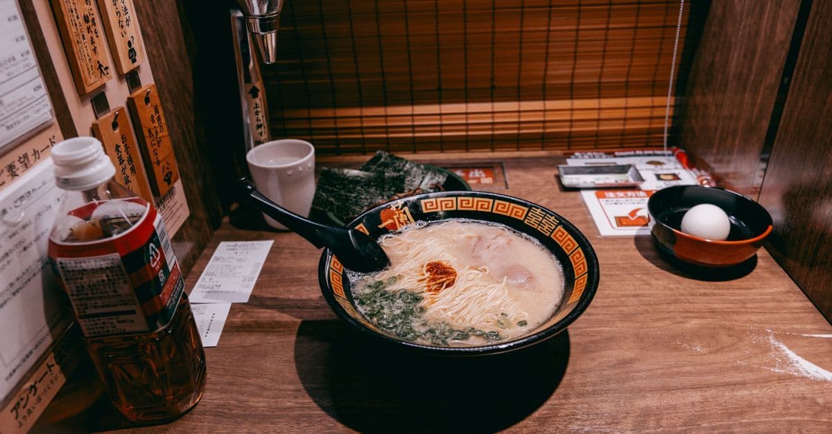 Steaming bowl of ramen served in a cozy private dining booth in Tokyo, Japan