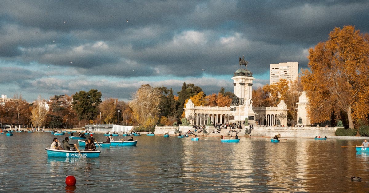 People boating near the Monument to Alfonso XII in Retiro Park, Madrid.