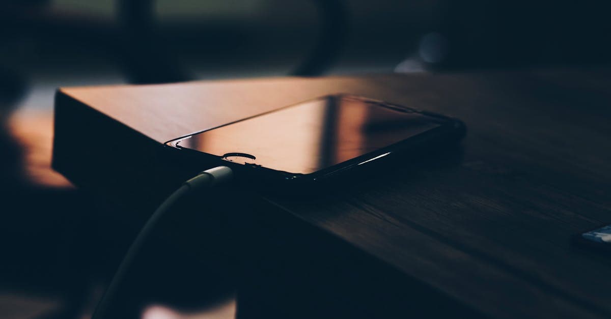 Smartphone on a wooden table charging indoors, an easy first step to avoid roaming charges in South Africa