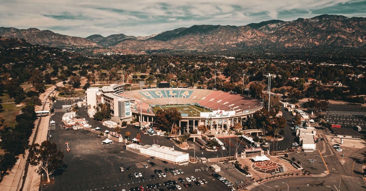 Aerial view of the Rose Bowl stadium nestled among mountains, a key Olympics 2028 Los Angeles venue for Canadian fans.
