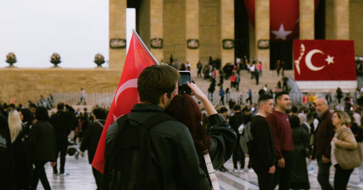 Crowds gathered at Anıtkabir in Ankara, waving Turkish flags during a national celebration.