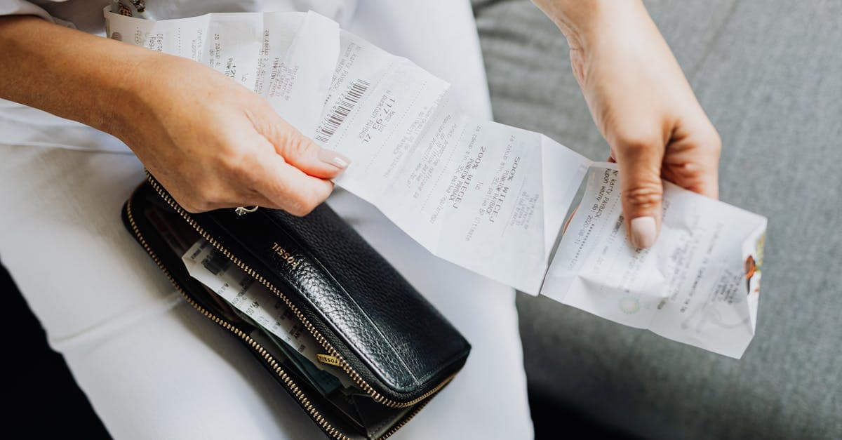 Woman's hands sorting receipts from a wallet, representing unexpected international roaming charges and bill shock overseas