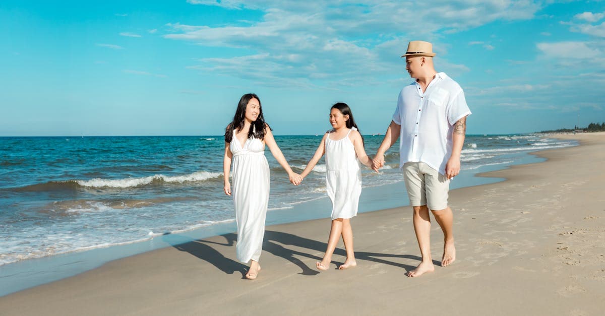 A happy family walking on Hội An's beach during summer, enjoying quality time together.