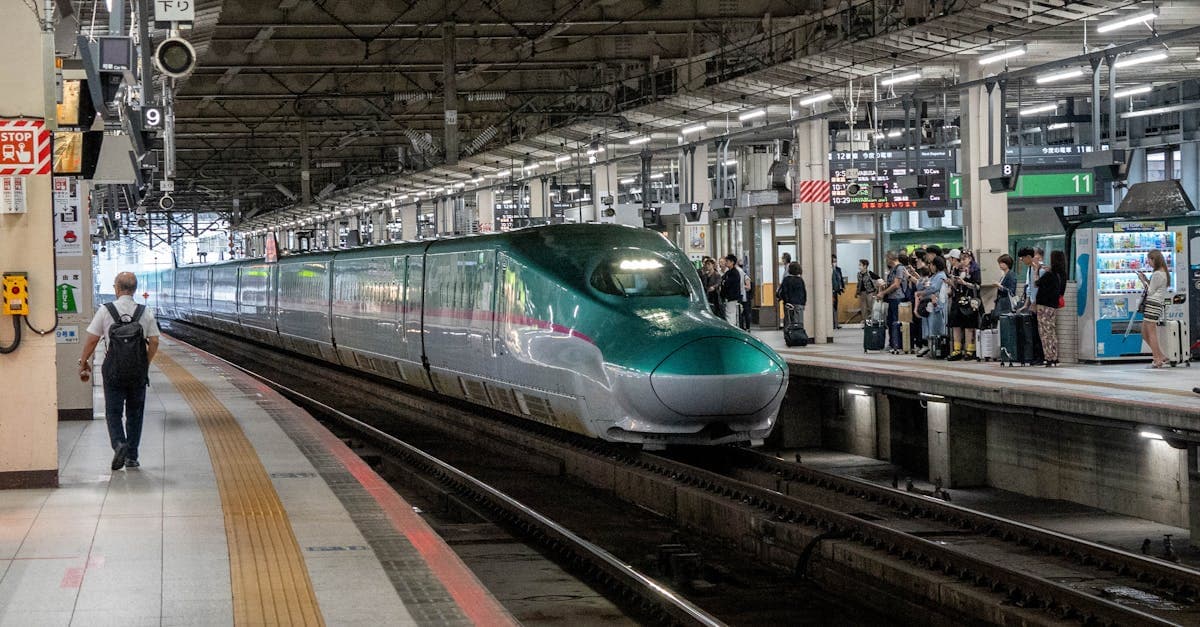 Shinkansen bullet train pulling into a Japanese station, where esim japan ensures seamless travel connectivity.