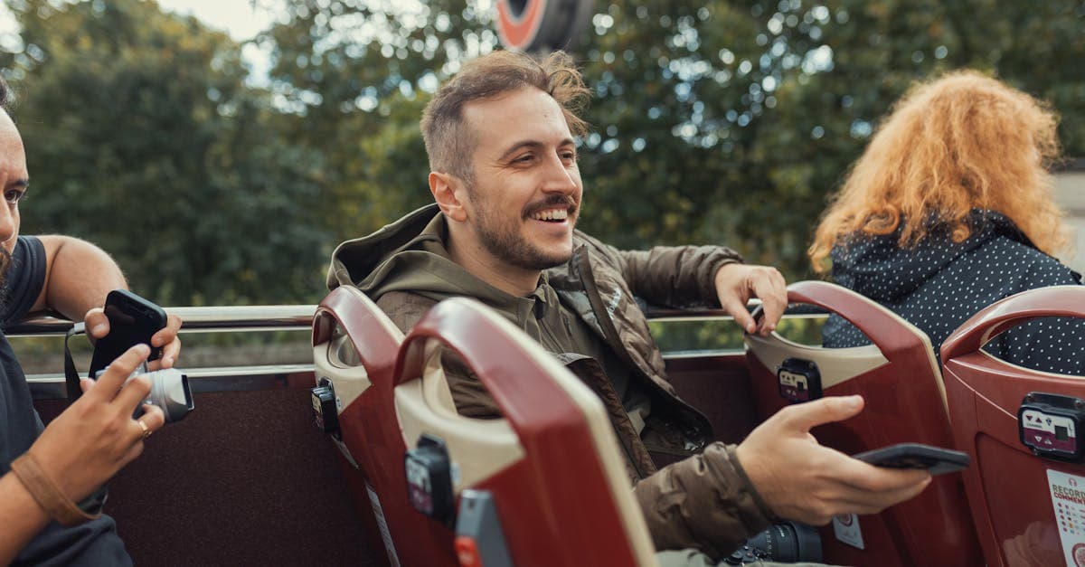 Happy tourists on an open-top London bus tour, covered by a travel eSIM across 39 European countries.