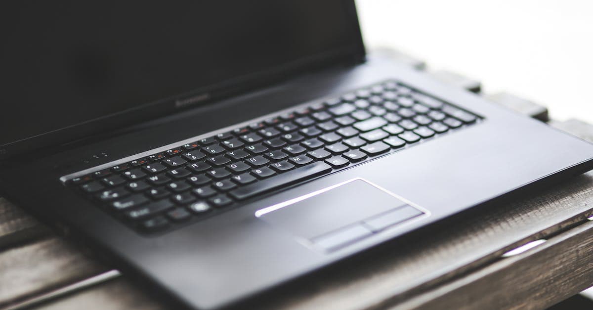 Sleek laptop on a rustic wooden table used to browse the best portable wifi plans in the UK