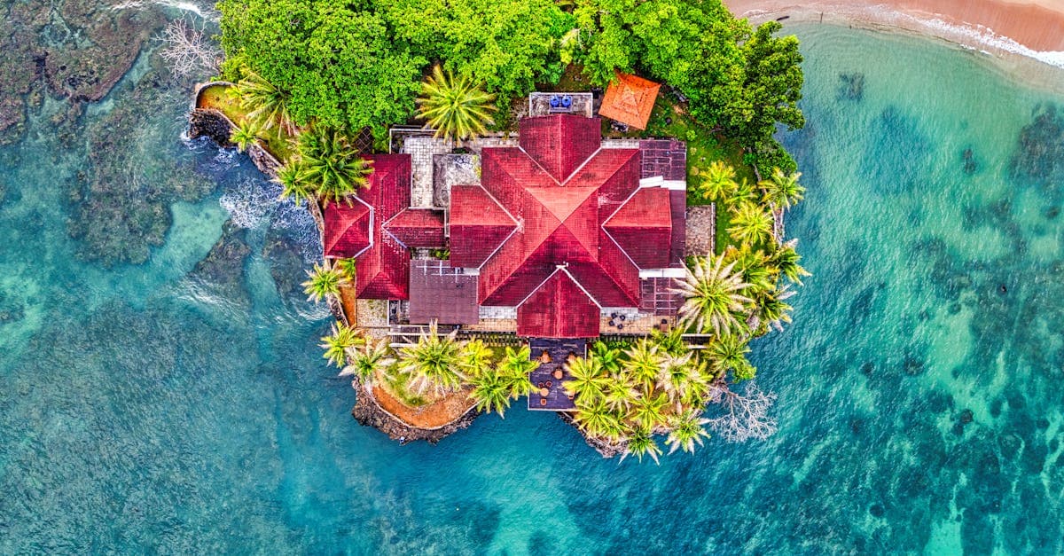 Aerial view of a Bali villa surrounded by turquoise water, showcasing top things to do in Bali in 2025