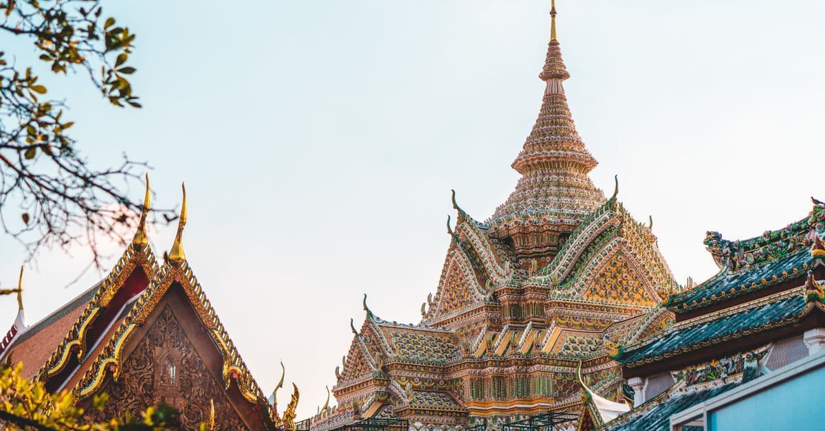 Ornate golden temple facade in Bangkok, a must-see cultural landmark on holidays to Thailand.