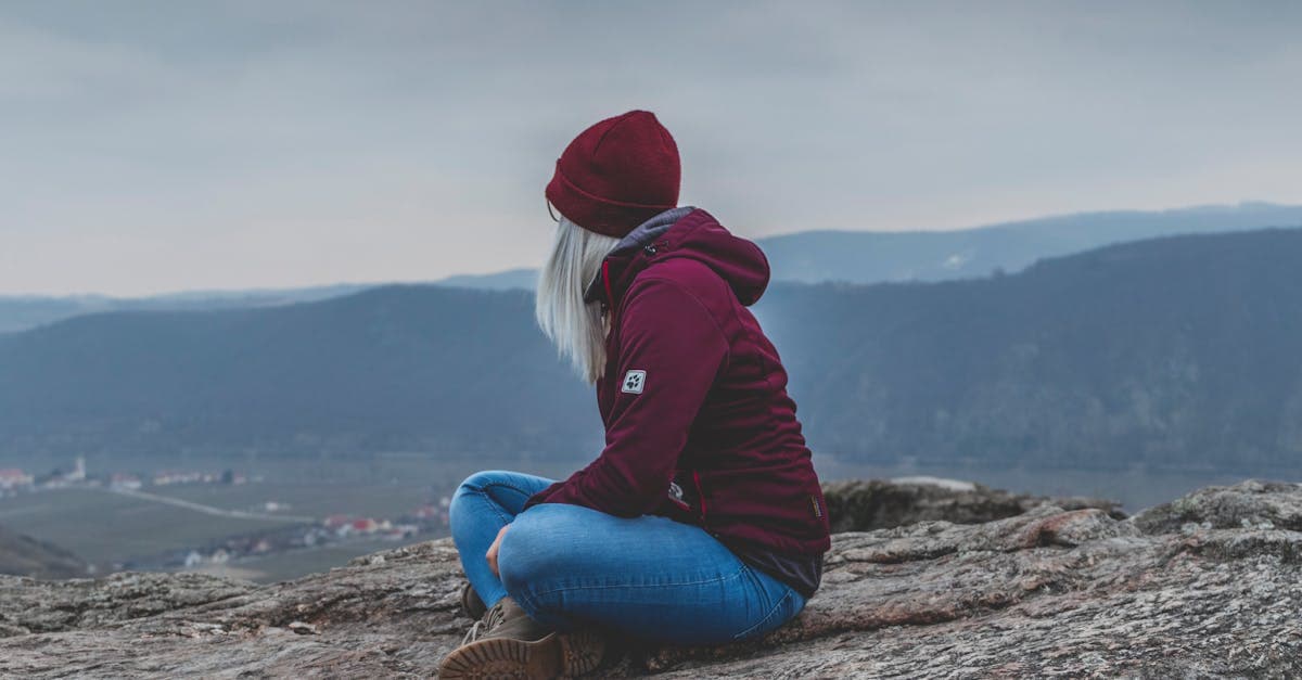 Woman in her 30s on a mountain summit proving solo travel in Europe has no age limit