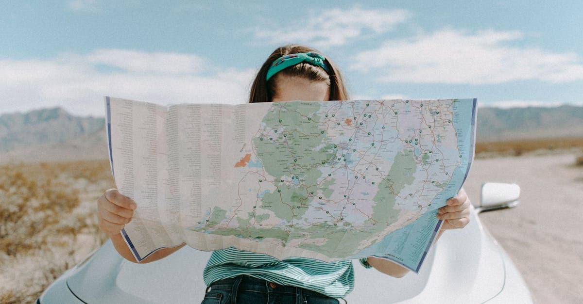 Solo woman traveller holding a map while exploring the scenic California desert highway