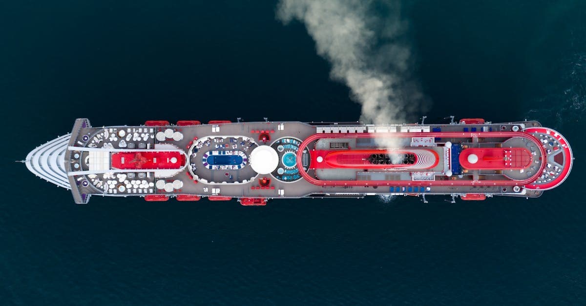 Drone shot highlighting Carnival Adventure deck plans as the ship navigates the scenic waters of Kotor Bay, Montenegro
