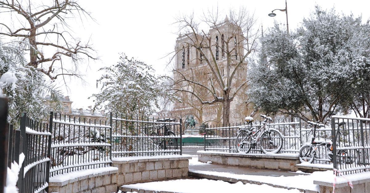 Notre Dame Cathedral blanketed in snow, illustrating how cold paris weather transforms iconic landmarks in winter.