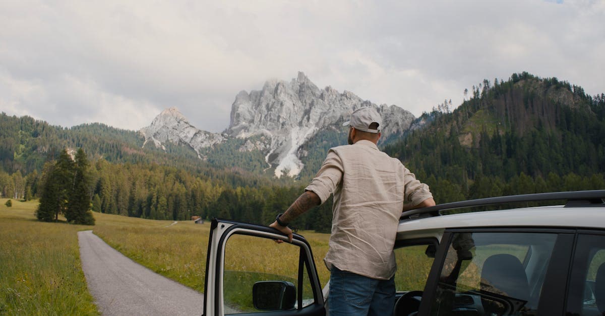 Viaggiatore scende dall'auto per ammirare il panorama mozzafiato delle Dolomiti durante un road trip in Italia