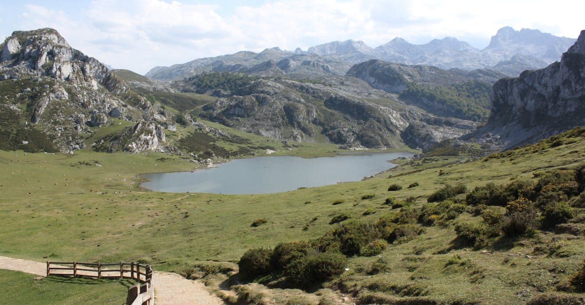 Scenic mountain lake view in Asturias, Spain, showcasing pristine nature and rugged terrain.