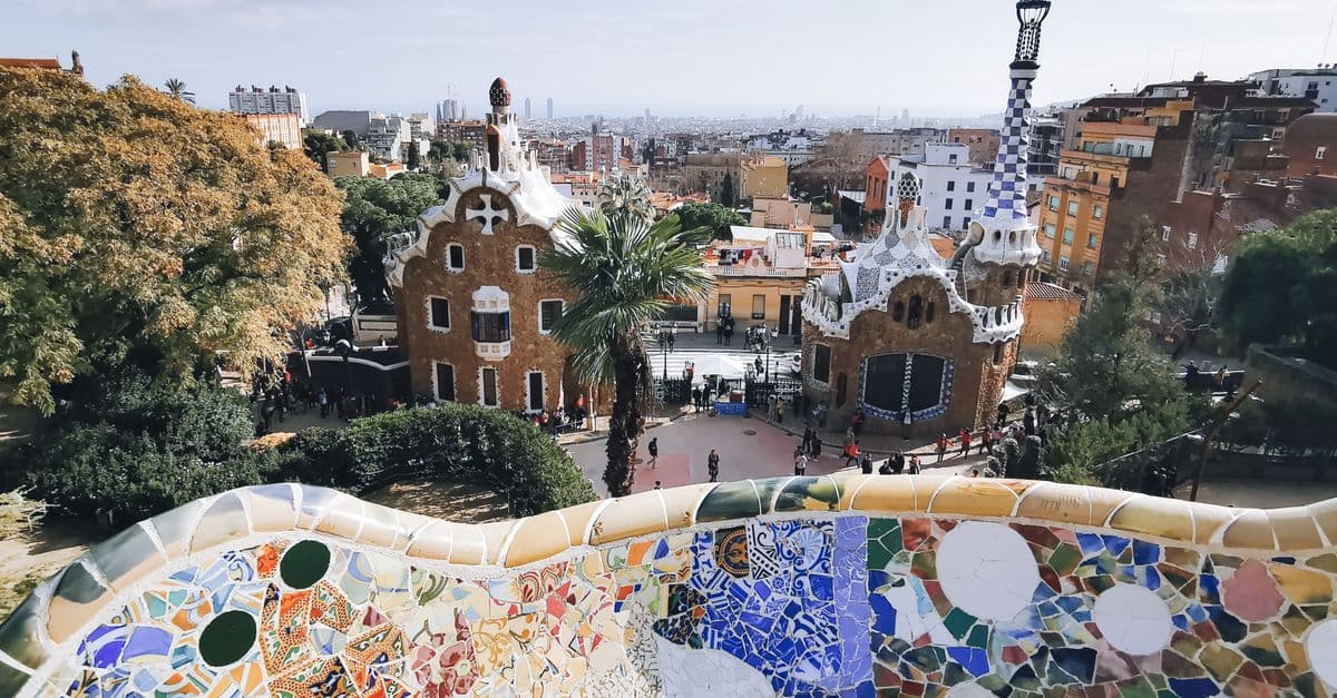 Colourful mosaic tiles and curved benches at Park Güell, one of Barcelona's most iconic sights