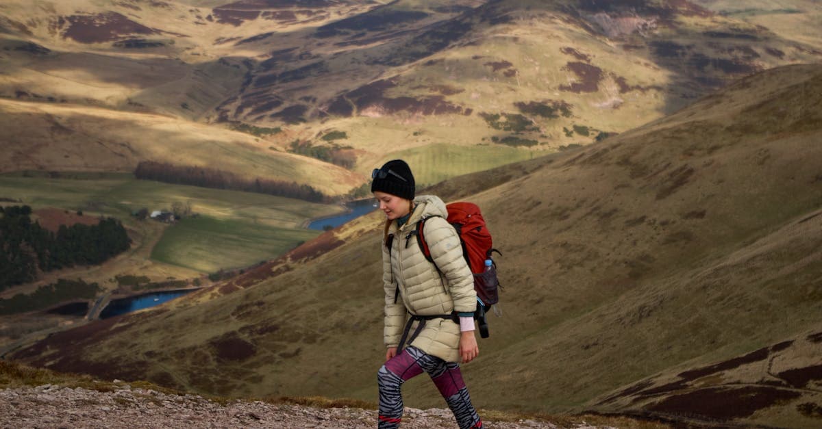 Woman hiking through Scotland's Pentland Hills on a clear day, a pursuit that may need add-on adventure cover