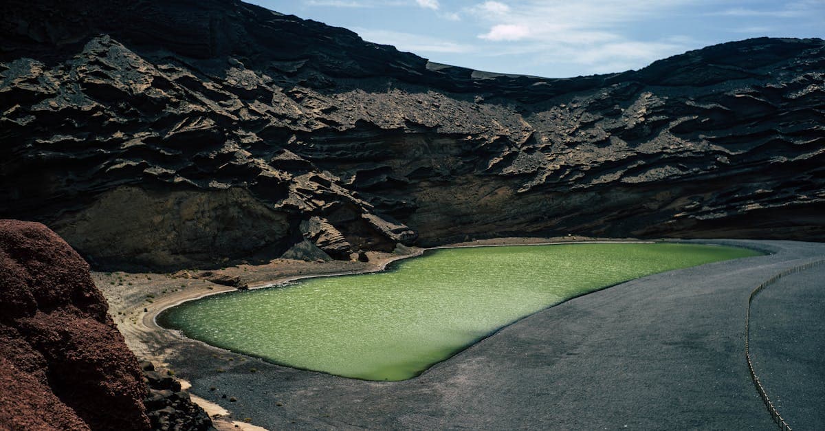 Vivid green volcanic lagoon at El Golfo, a natural wonder and must-see among things to do in Lanzarote