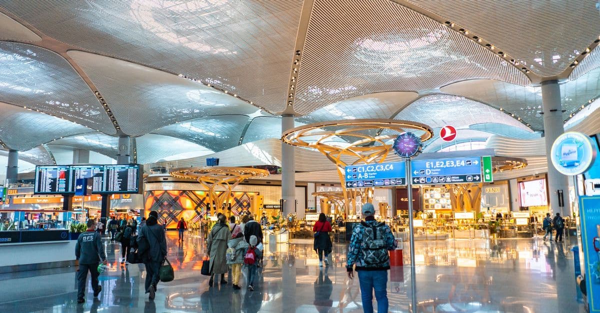 Przestronne wnętrze sharjah airport z licznymi sklepami, strefami odpoczynku i podróżnymi przy odprawie.