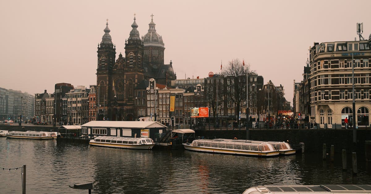 Amsterdam's iconic canals and gabled houses on a misty morning, answering questions about things to do in amsterdam