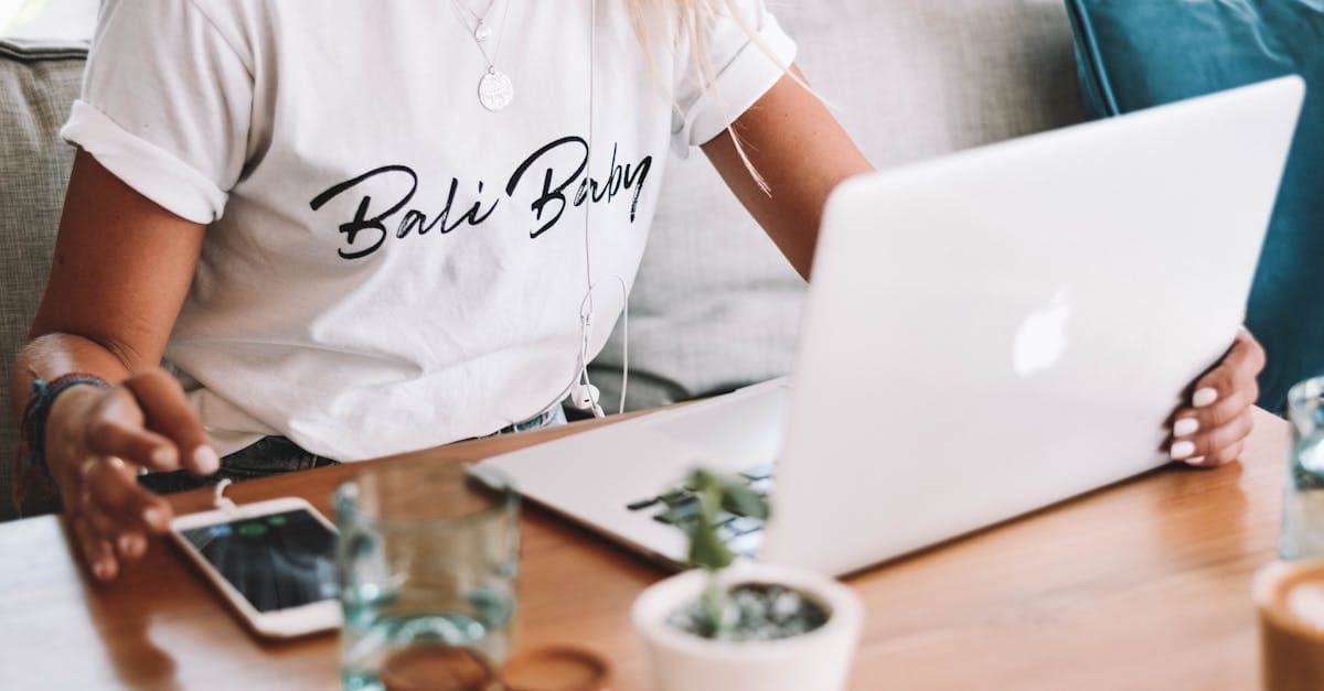 Woman working remotely on wooden table outdoors in Bali, staying connected as a digital travel eSIM Bali