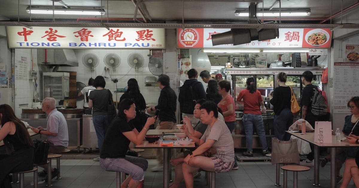 Locals and tourists dining at Tiong Bahru Pau hawker centre, illustrating what to eat in Singapore