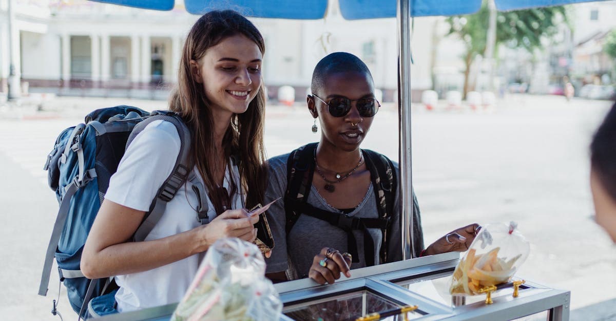 Two women backpackers exploring local street food, enjoying affordable data with a local prepaid SIM card.