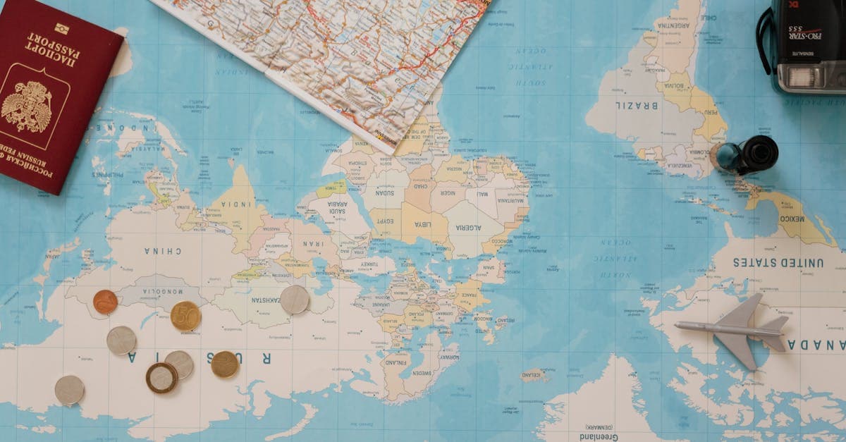 Flat lay of passport, world map, and coins for planning international roaming eSIM options in New Zealand.