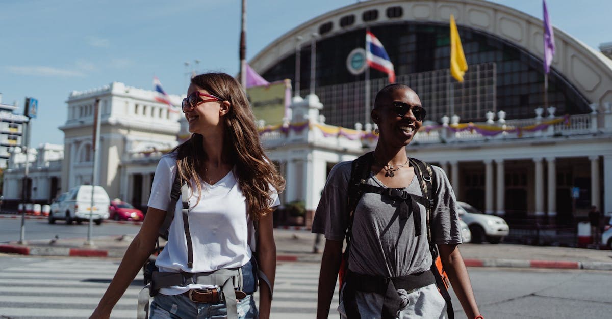 Two women backpackers crossing a city street using their home carrier's international roaming pass.