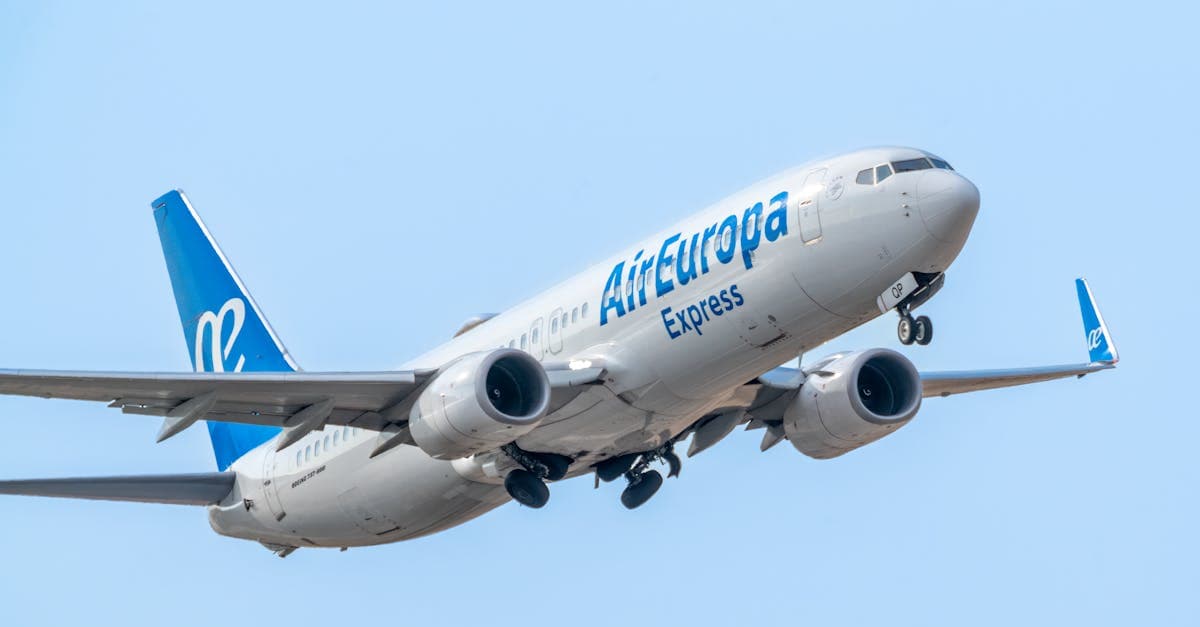 Air Europa Express Boeing 737-800 taking off against a clear blue sky.