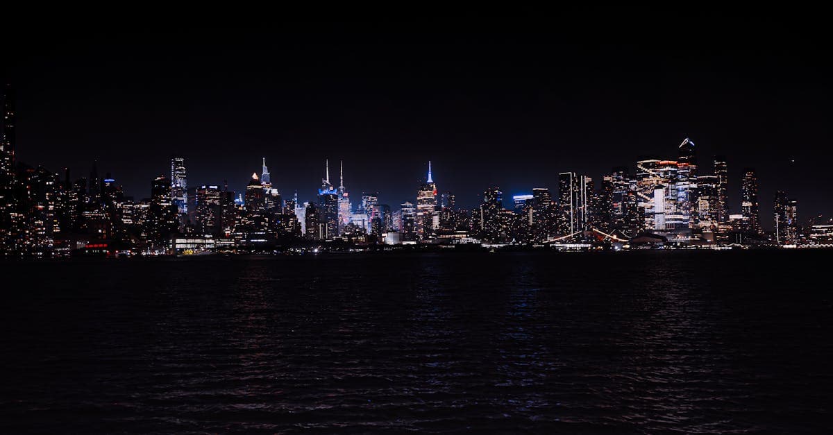 Breathtaking night view of the illuminated New York City skyline across the water.