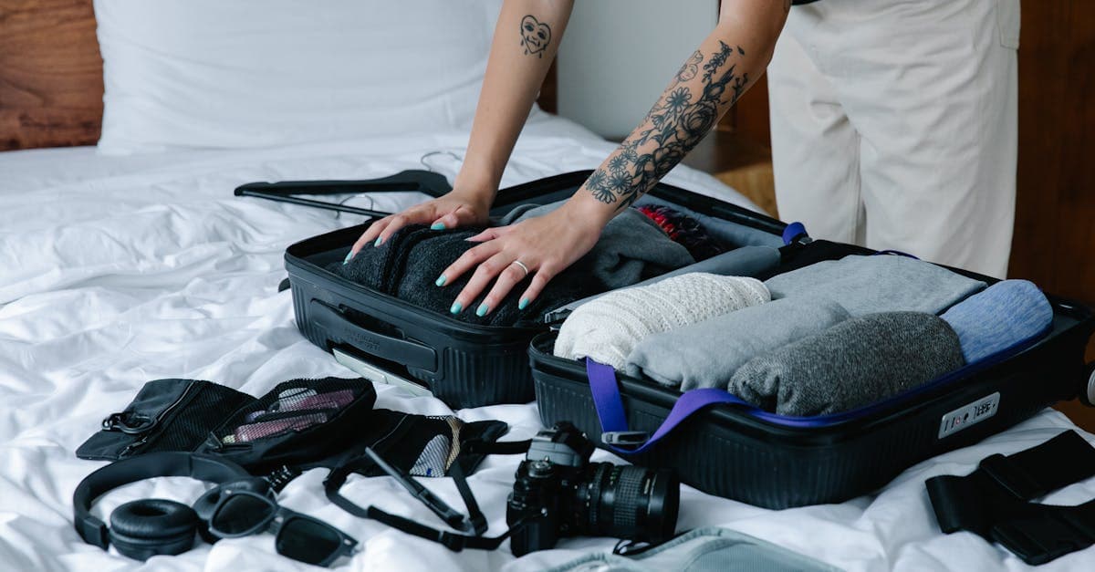 ベッドの上でスーツケースに荷物を詰める女性、ヨーロッパ旅行出発前の準備チェックリスト