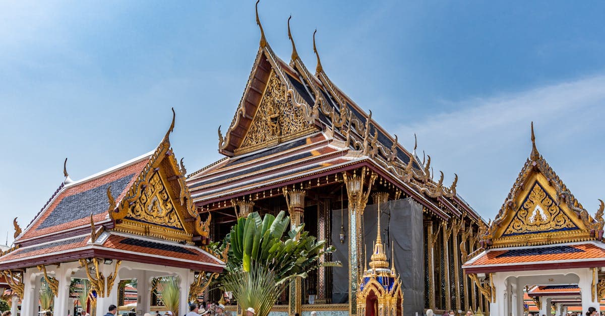 Tourists exploring Wat Phra Kaew Bangkok, best time to visit Thailand differs by region, island, and season
