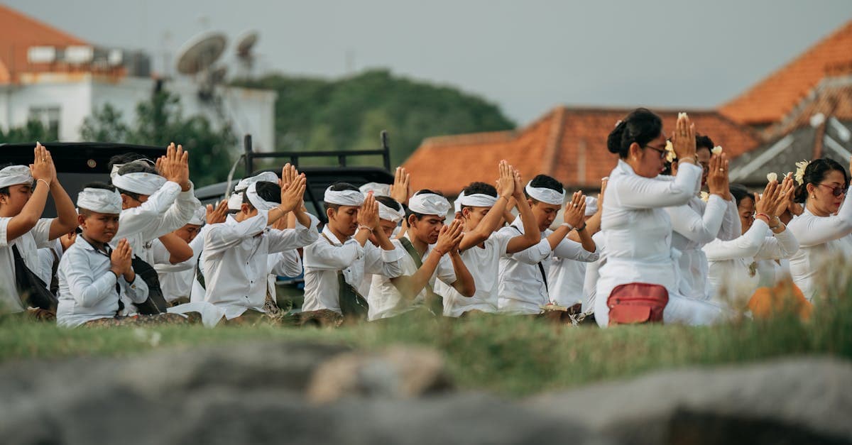 Balinese community participating in a traditional outdoor prayer ceremony during Galungan festival celebrations