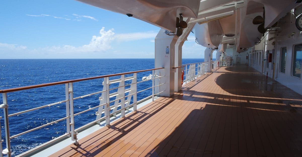 Upper deck stateroom view on Carnival Adventure deck plans showing lifeboats, railings, and open ocean.