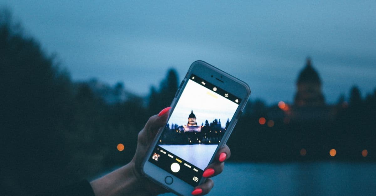 Smartphone capturing the Capitol Building at twilight, illustrating eSIM compatibility across android vs iphone models